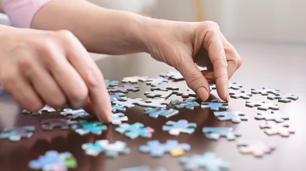 Memory care resident completing puzzle for cognitive stimulation