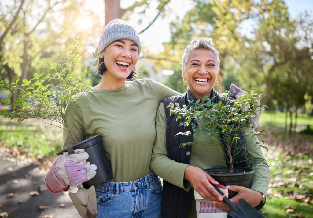 Memory care resident gardening with volunteer
