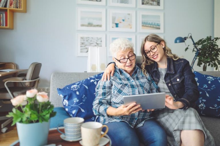 Family member sitting with aging loved one