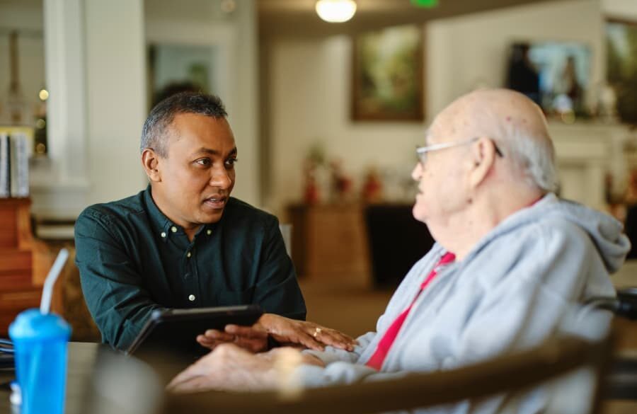 Healthcare worker talking to senior citizen in community