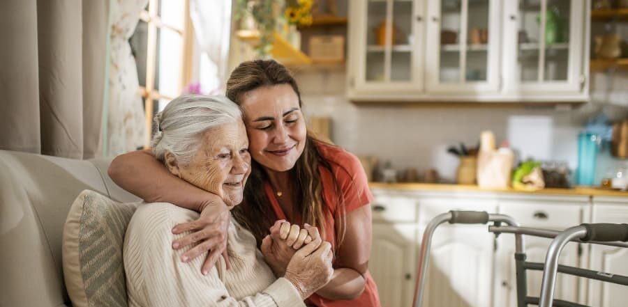Daughter assisting family member with walker at home