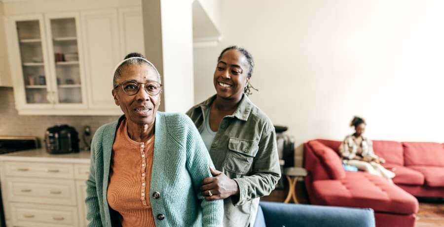 Younger adult helping older adult at home