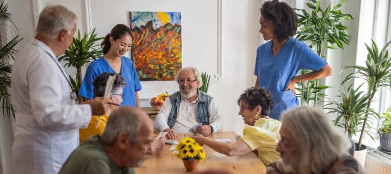 Happy residents playing cards in nursing home