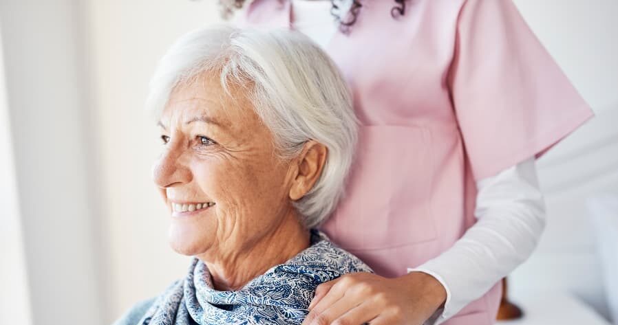 Cropped shot of nurse with resident sitting down
